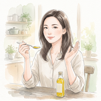 女性が小さじ1杯のオイルを手に、かけすぎず適量を守ることを表したイメージ