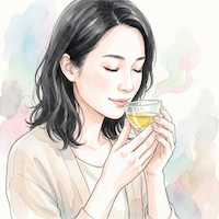 小さなグラスにそそいだ油の香りを、目を閉じてそっと確かめている女性