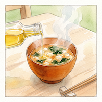温かい味噌汁に食べる直前のオメガ3オイルを回しかける、後がけのイメージ