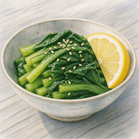 ヴィーガンダイエットで非ヘム鉄の吸収を上げる食べ方。小松菜のおひたしにレモンとごまを添えた小鉢を描いた水彩イラスト